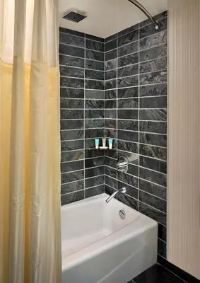 a bathroom with a tub and a shower curtain at Hyatt Regency Vancouver in Vancouver