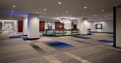 a lobby of a hotel with a chandelier at Hyatt Regency Vancouver in Vancouver