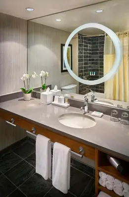 a bathroom with a sink and a mirror at Hyatt Regency Vancouver in Vancouver