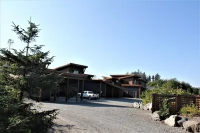 a house with a car parked in the driveway at Oceanview Condo - Pacific Rim Retreat in Ucluelet