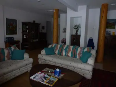 a living room with two couches and a coffee table at Little Black Bear Lodge/B&B in Bridge Lake