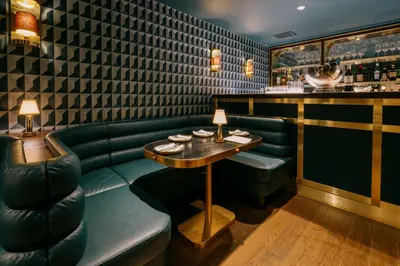 a restaurant with a green couch and a table at Eleven Revelstoke Lodge in Revelstoke