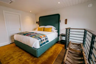 a bedroom with a bed with a green headboard at Eleven Revelstoke Lodge in Revelstoke