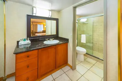 a bathroom with a sink and a toilet and a mirror at Charltons Banff in Banff