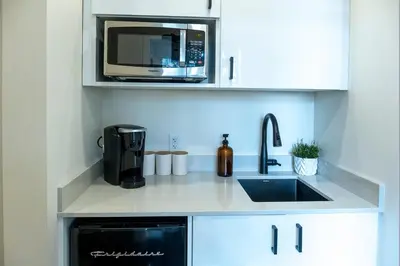a kitchen with a sink and a microwave at The Francis Boutique Inn in Ucluelet