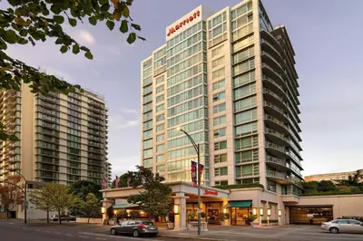 a tall building with cars parked in front of it at Victoria Marriott Inner Harbour in Victoria