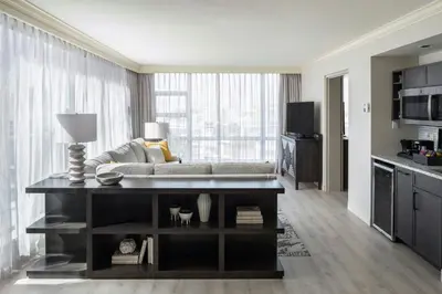 a living room with a couch and a table at Victoria Marriott Inner Harbour in Victoria