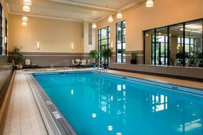 a swimming pool with blue water in a hotel at Victoria Marriott Inner Harbour in Victoria