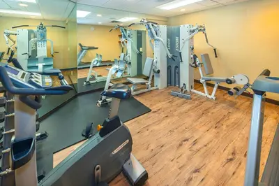 a gym with treadmills and machines in a room at Royal Canadian Lodge in Banff