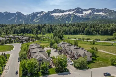an aerial view of a resort with mountains at Riverside by StayIn in Fernie