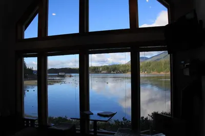 a view of a lake from a window at Private Oceanfront Cabin With Hot Tub Doc Holiday Cabin in Ucluelet