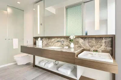 a bathroom with a sink and a toilet and a mirror at Civic Hotel, Autograph Collection in Surrey