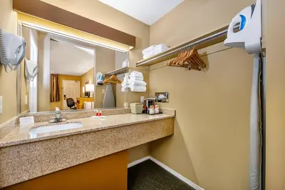 a bathroom with a sink and a mirror at Econo Lodge Inn & Suites in North Vancouver