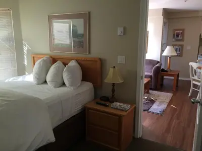a bedroom with a bed and a table with a lamp at Times Square Suites Hotel in Vancouver