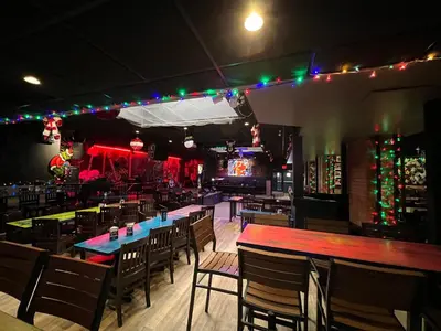 a restaurant with tables and chairs and christmas lights at Commercial Hotel in Edmonton