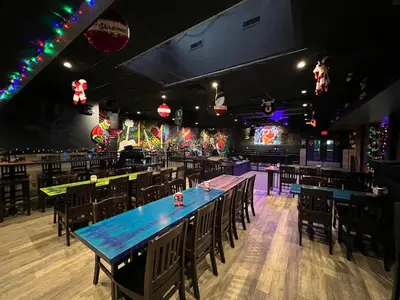 a dining room with tables and chairs and lights at Commercial Hotel in Edmonton