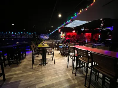 a bar with tables and chairs in a restaurant at Commercial Hotel in Edmonton