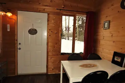 a room with a white table and a window at Rocky Ridge Resort-BC in Smithers
