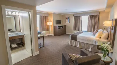 a hotel room with a bed and a living room at MStar Hotel in Kitimat