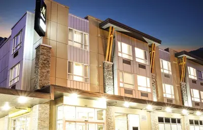 a large building with flags on the side of it at MStar Hotel in Kitimat