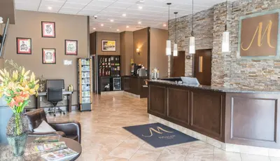 a lobby of a salon with a reception desk at MStar Hotel in Kitimat