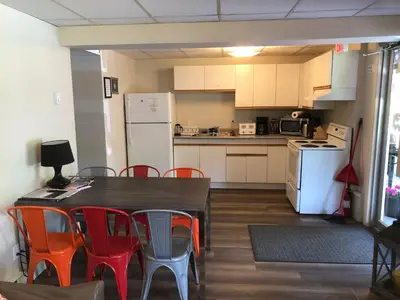 a kitchen with a table and chairs and a white refrigerator at Stewart Mountain Lodge in Stewart