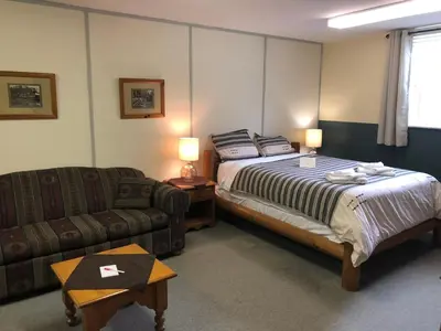 a hotel room with a bed and a couch at Stewart Mountain Lodge in Stewart