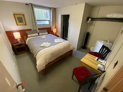 a bedroom with a bed and a table and chairs at Stewart Mountain Lodge in Stewart