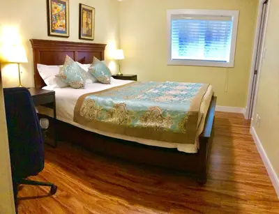 a bedroom with a bed and a window at Bay View House in Vancouver