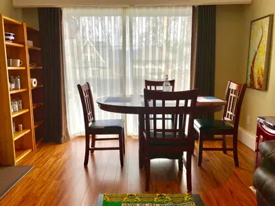 a dining room with a table and four chairs at Bay View House in Vancouver