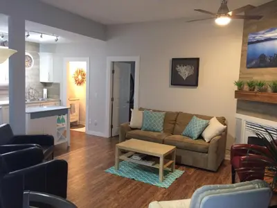 a living room with a couch and a table at Heart of Peachland in Peachland