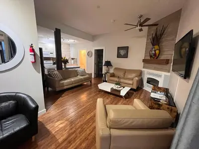a living room with two couches and a fireplace at Heart of Peachland in Peachland