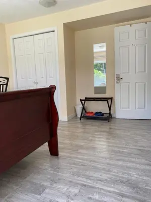 a living room with a couch and a door at Richmond Vancouver Airport Comfy Home in Richmond