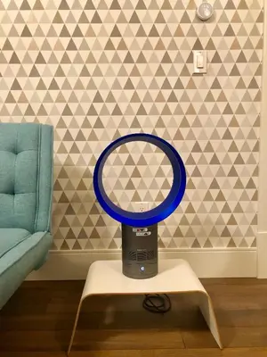 a blue mirror sitting on a table next to a couch at Boutique in Vancouver