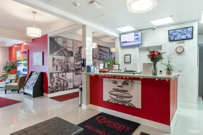 a restaurant with a counter with a picture of a face at Queens Hotel in New Westminster