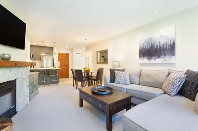 a living room with a couch and a table at Aspens Mountain Side Resort in Whistler