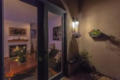 a hallway with a door to a room with flowers at Whytecliff Park place near ocean in West Vancouver
