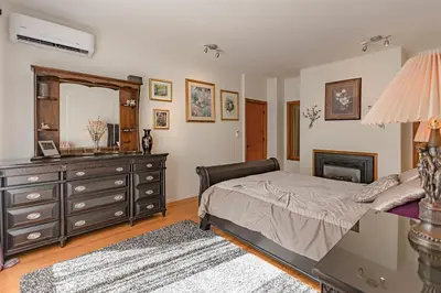 a bedroom with a bed and a dresser and a mirror at Whytecliff Park place near ocean in West Vancouver