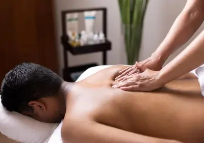 a man getting a massage from a therapist at The Cove Lakeside Resort in West Kelowna