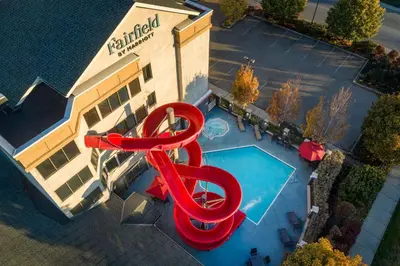 an overhead view of a swimming pool with a red water slide at Fairfield Inn & Suites by Marriott Kelowna in Kelowna