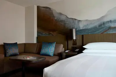 a hotel room with a bed and a couch at Calgary Marriott Downtown Hotel in Calgary