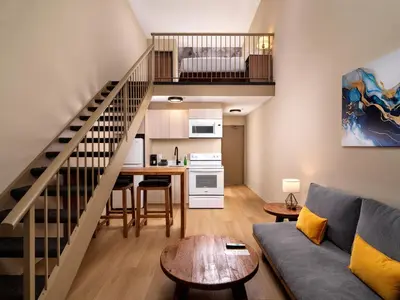 a living room with a couch and a table at Huntingdon Hotel and Suites in Victoria