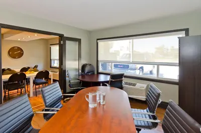 a dining room with a table and chairs and a window at Centro Motel in Calgary