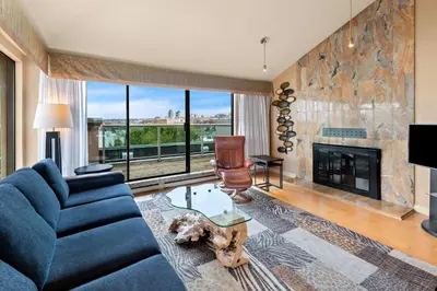 a living room with a blue couch and a fireplace at Best Western PLUS Inner Harbour Hotel in Victoria