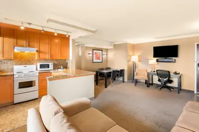 a kitchen and living room with a couch and a table at Best Western PLUS Inner Harbour Hotel in Victoria