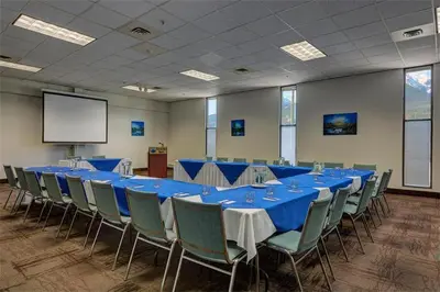 a conference room with a long table and chairs at Sea to Sky Hotel and Conference Centre in Squamish