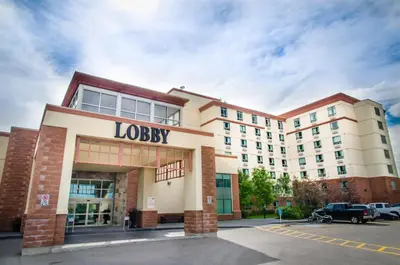 a large building with a louisbush hotel at Deerfoot Inn and Casino in Calgary