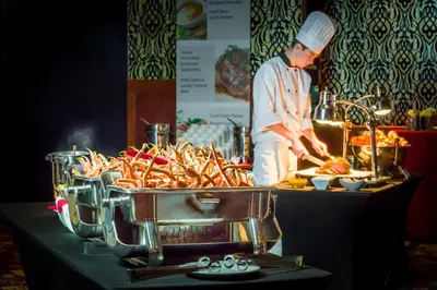 a chef preparing food in front of a buffet at Deerfoot Inn and Casino in Calgary