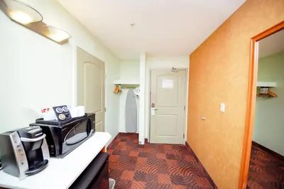a hotel room with a television on a counter at Service Plus Inns and Suites Calgary in Calgary
