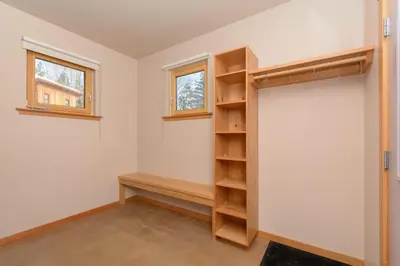 a room with a closet with shelves and a window at The Mountain Project #2 in Rossland